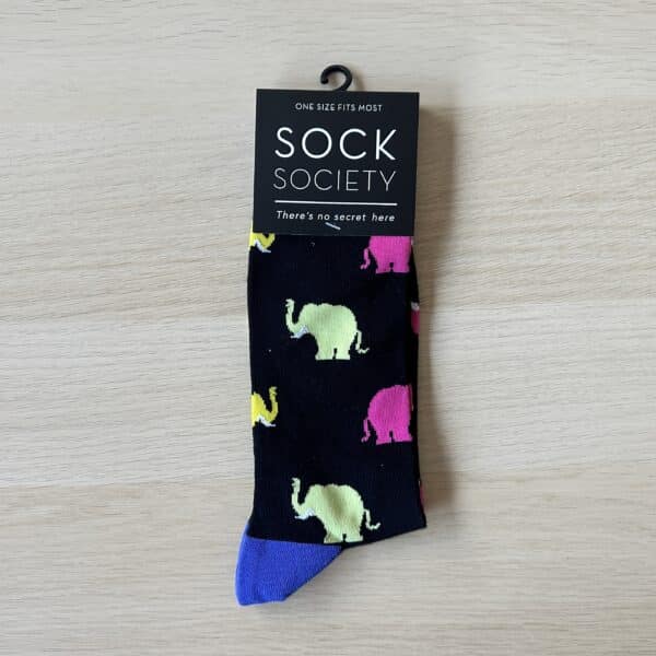 black sock with blue and pink elephants on them. facing right