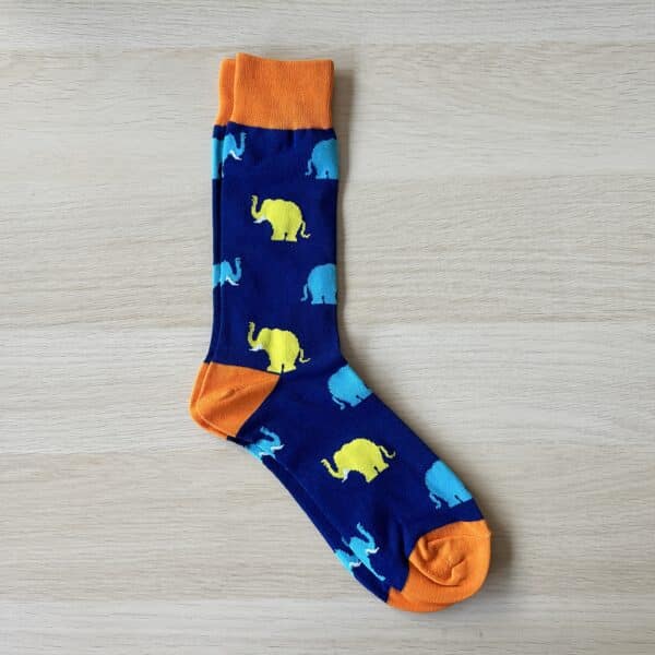 blue sock with blue and yellow elephants on them with a sock society label