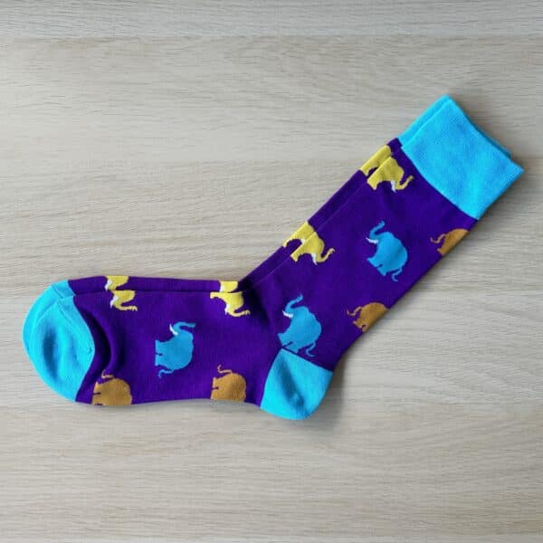 purple sock with blue and yellow elephants on them pointing left