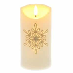 cream pillar candle with a gold snowflake candle